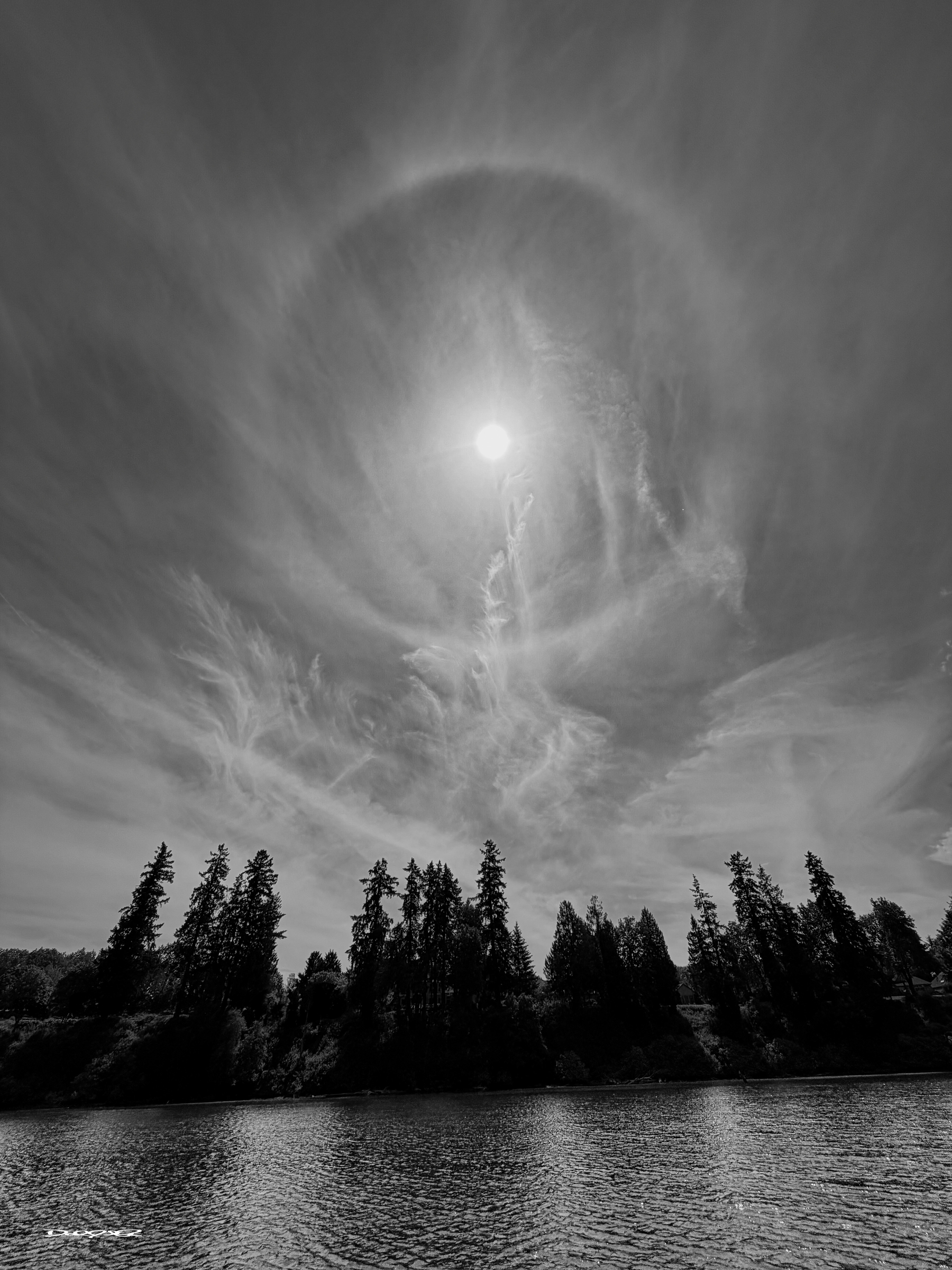 A sun halo (or 22° halo) is a bright, white, or occasionally colored ring appearing around the Sun, caused by sunlight refracting through, or reflecting off, millions of tiny hexagonal ice crystals suspended in high-altitude cirrus or cirrostratus clouds. They often indicate incoming moisture and weather changes.